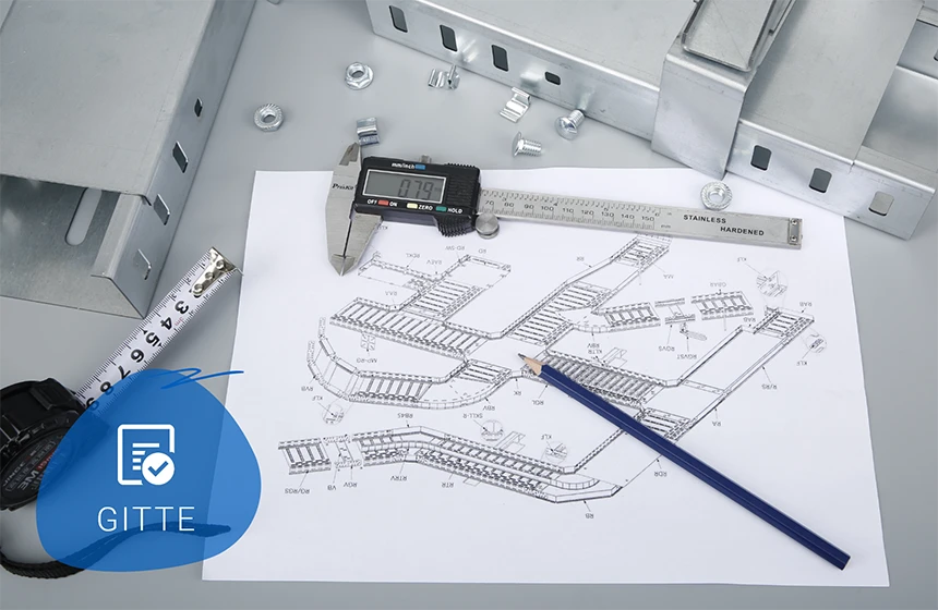 Parts and design drawings are placed on the desk